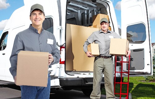 Team loading items into a removal truck